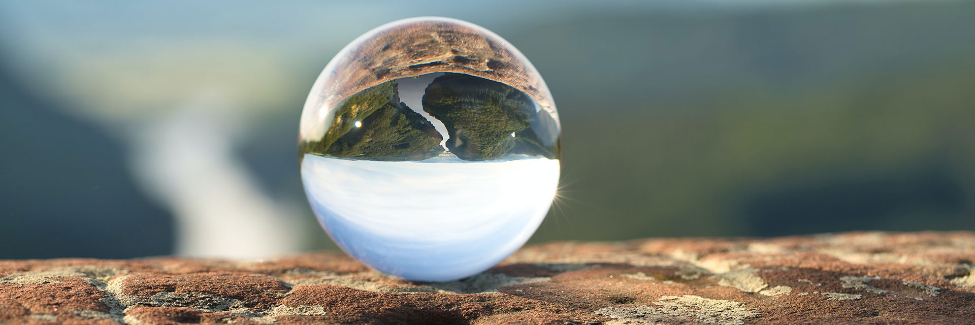 Clear marble on brown rock.